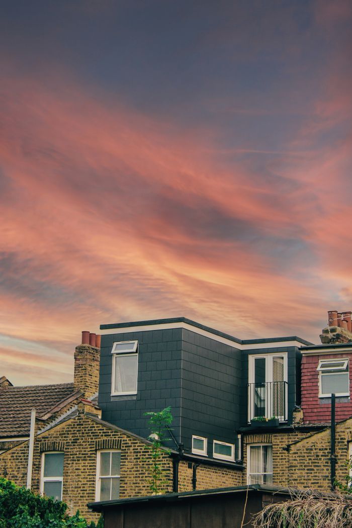 services-01 Picturesque scene of London houses against a vibrant sunset sky.