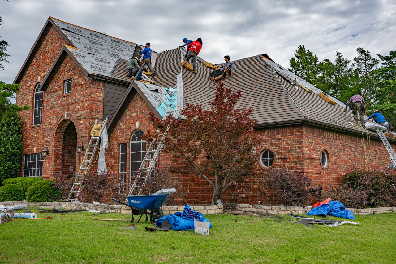 Crafting Captivating Headlines: Your awesome post title goes here Roofers working on brick home in Allen, Texas, addressing shingles and roofing materials.